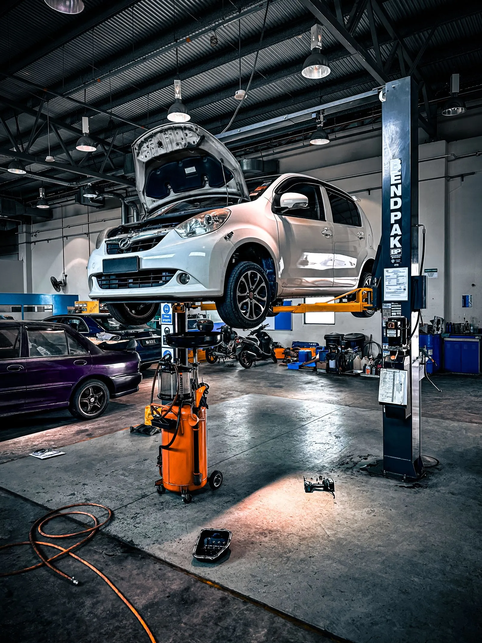 Vehicle raised on a lift in a professional auto repair bay
