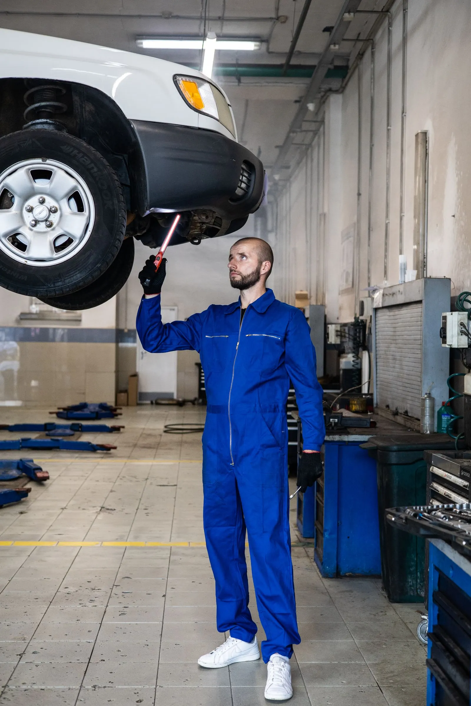 Autotech technician inspecting a vehicle on a lift